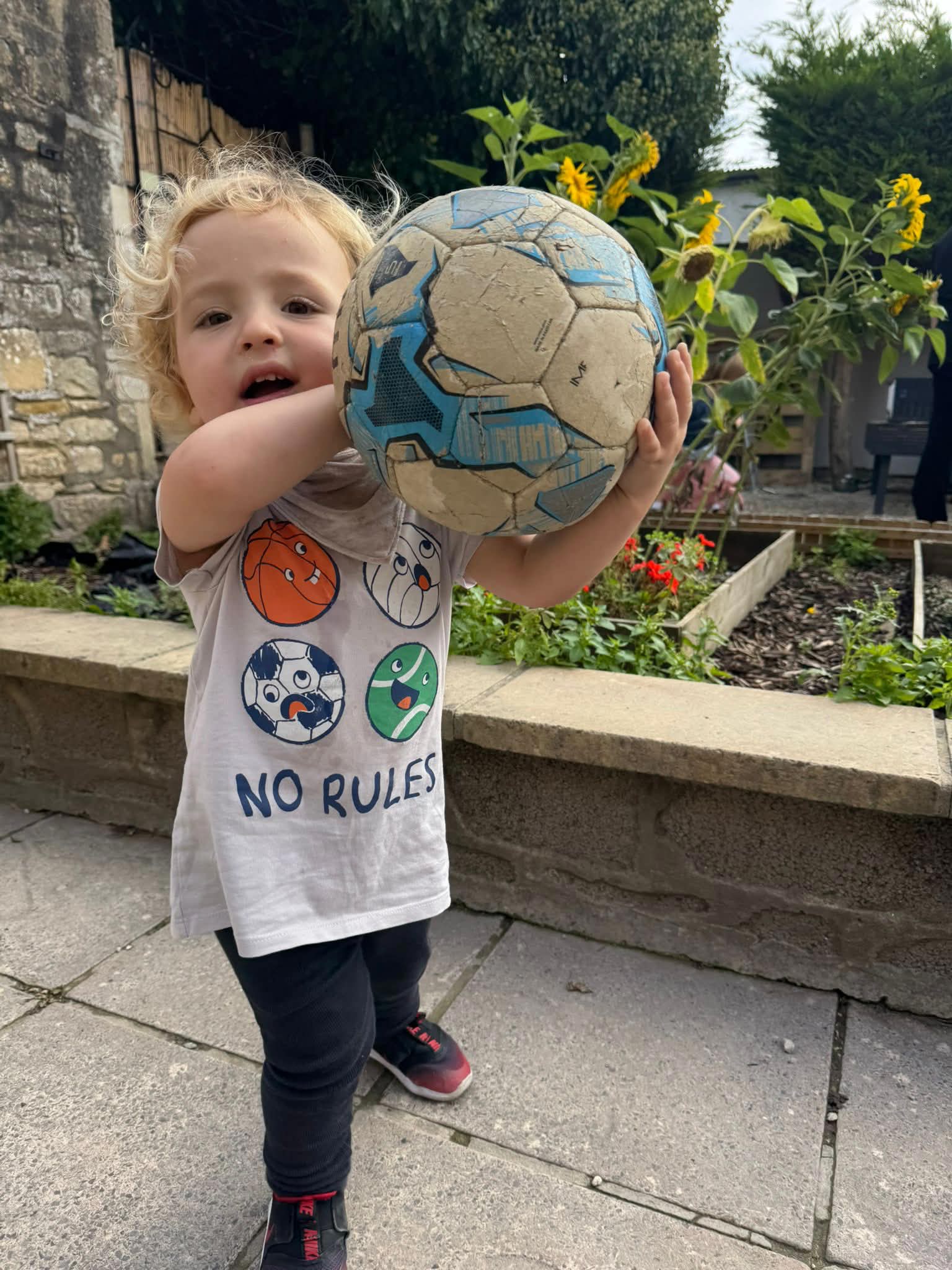 Child holding up ART letters